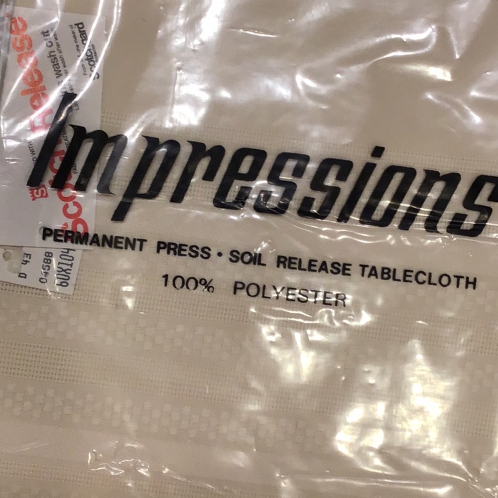 NEW 60”X104” oval tablecloth, 100% polyester NWTs light Beige. Great gift!